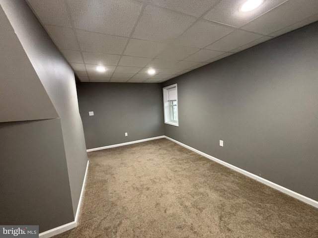 basement featuring carpet flooring and a drop ceiling