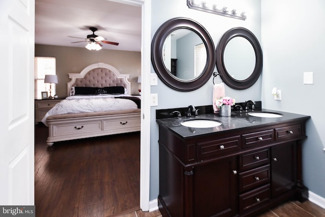 bathroom with hardwood / wood-style floors, ceiling fan, and vanity