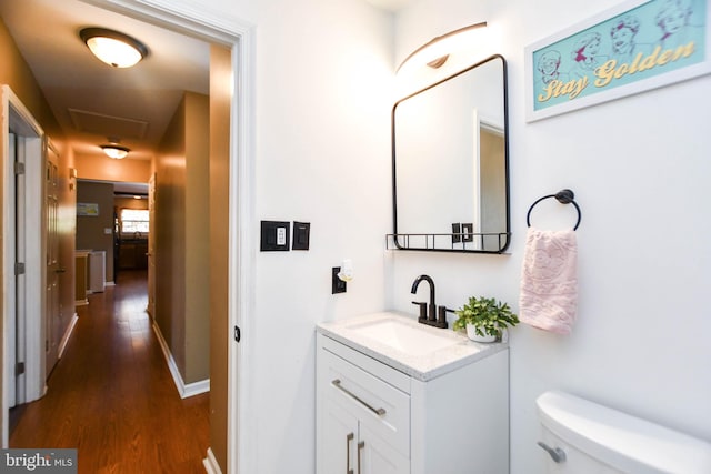 bathroom featuring hardwood / wood-style floors, vanity, and toilet