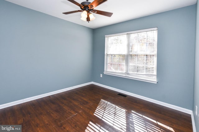 empty room with hardwood / wood-style floors and ceiling fan