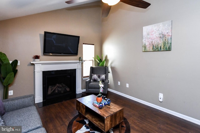 living room with dark hardwood / wood-style flooring and ceiling fan