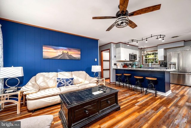 living room with ceiling fan, hardwood / wood-style floors, and crown molding