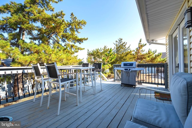 wooden terrace featuring grilling area