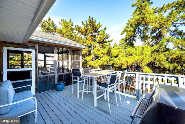 wooden deck with a sunroom