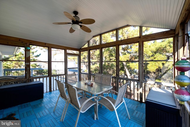 unfurnished sunroom with ceiling fan and lofted ceiling