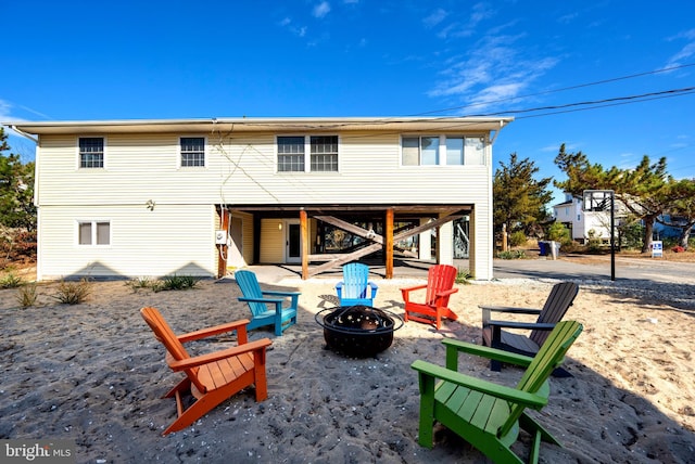 rear view of property with a fire pit and a patio area