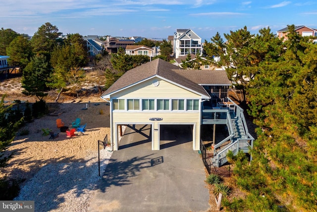 view of front of house featuring a carport and a sunroom