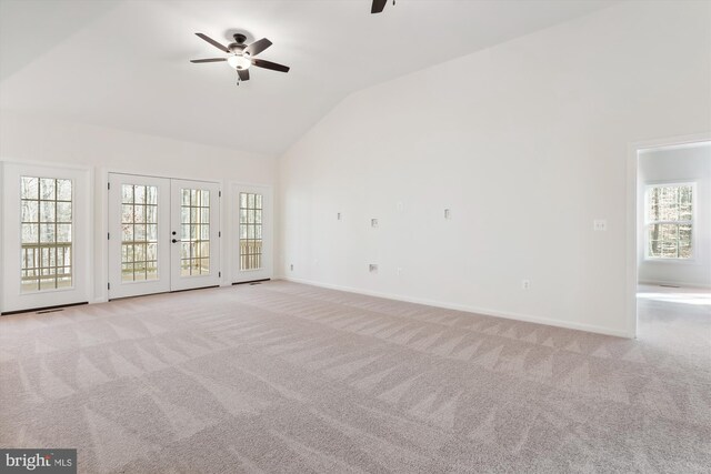 unfurnished living room with ceiling fan, light carpet, and a healthy amount of sunlight