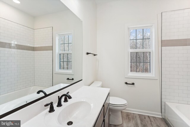 bathroom with hardwood / wood-style flooring, vanity, and toilet