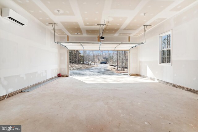 garage with an AC wall unit and a garage door opener