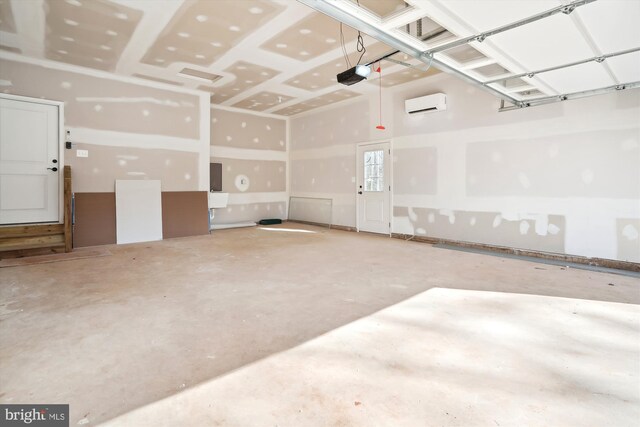 garage featuring a garage door opener and a wall mounted air conditioner