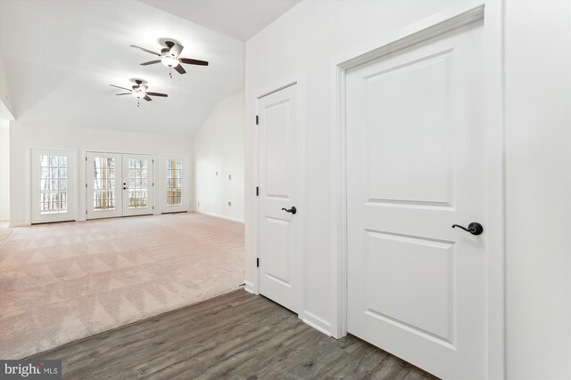 interior space with ceiling fan, vaulted ceiling, dark hardwood / wood-style floors, and french doors