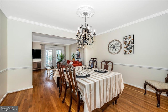 dining area featuring french doors, hardwood / wood-style floors, and crown molding