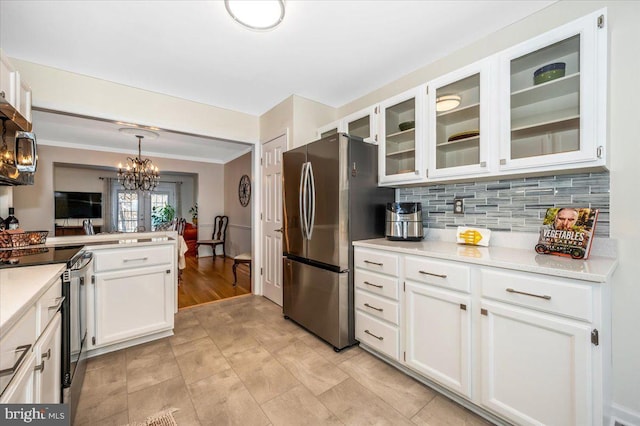 kitchen with stainless steel appliances, white cabinets, and hanging light fixtures