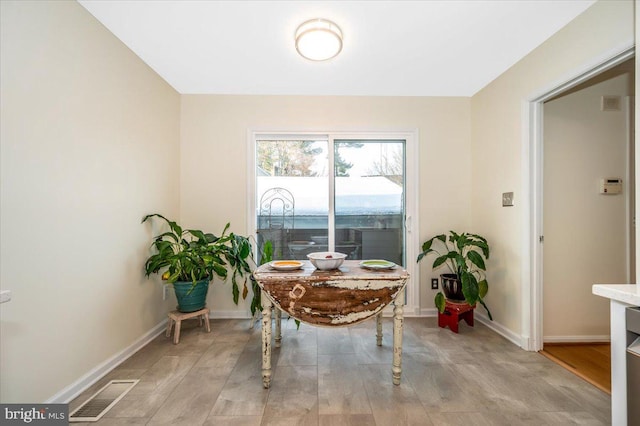 dining space featuring light wood-type flooring