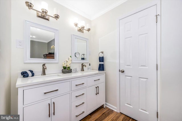 bathroom with ornamental molding, hardwood / wood-style floors, and vanity