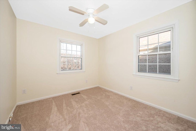 empty room with ceiling fan and light colored carpet