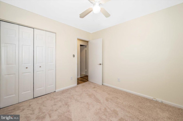 unfurnished bedroom with a closet, ceiling fan, and light colored carpet