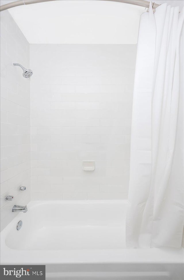 bathroom featuring shower / bath combination with curtain