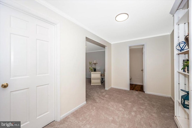 hallway featuring light carpet and ornamental molding