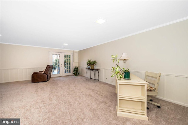 living area with french doors, light carpet, and ornamental molding