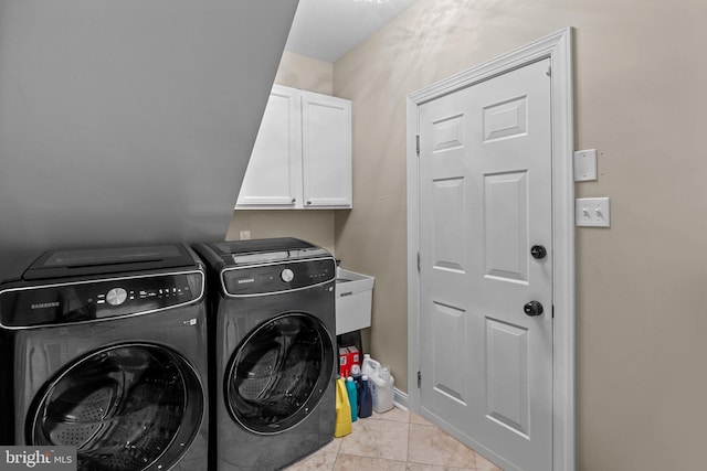 laundry area featuring cabinets, independent washer and dryer, and light tile patterned floors