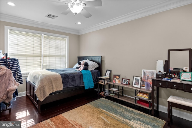 bedroom with dark wood-type flooring, ceiling fan, and crown molding