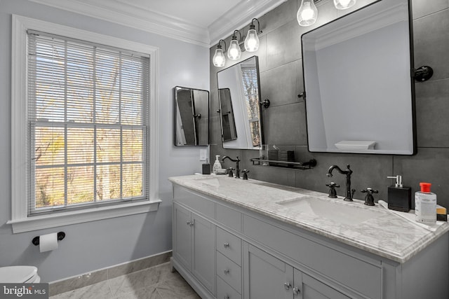 bathroom featuring ornamental molding, decorative backsplash, vanity, and a healthy amount of sunlight