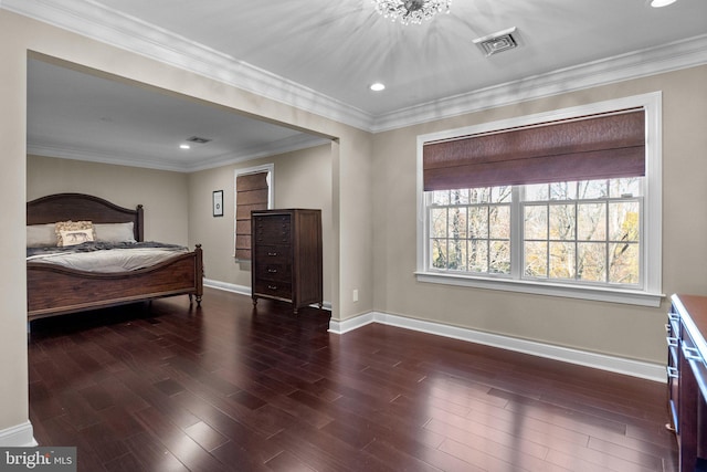 bedroom with ornamental molding, dark hardwood / wood-style flooring, and an inviting chandelier