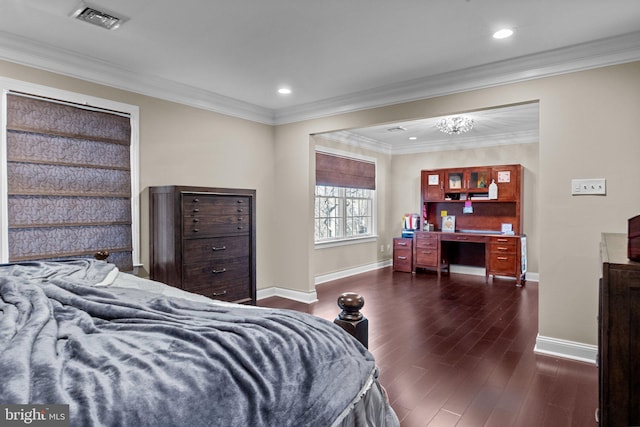 bedroom featuring dark hardwood / wood-style floors, a chandelier, and crown molding