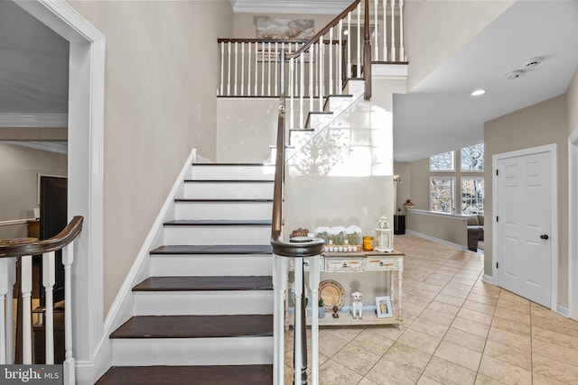 stairway featuring tile patterned floors and crown molding