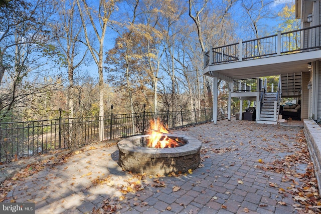 view of patio featuring an outdoor fire pit and a wooden deck