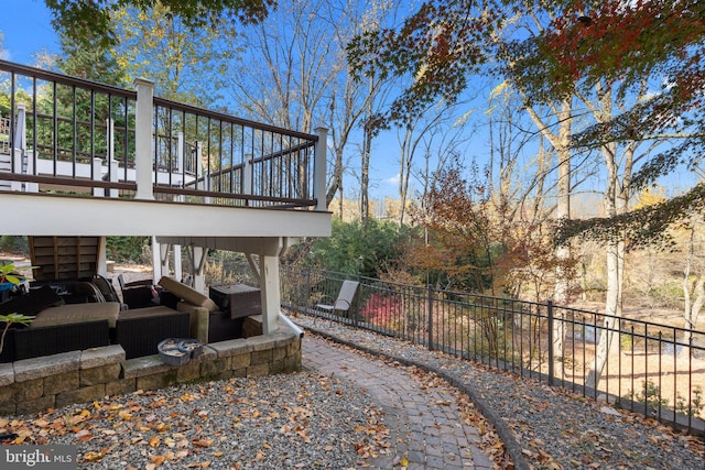 exterior space featuring outdoor lounge area and a wooden deck