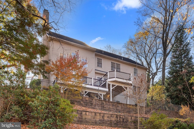 back of property featuring a wooden deck