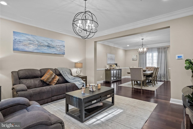 living room with a chandelier, dark hardwood / wood-style floors, and crown molding