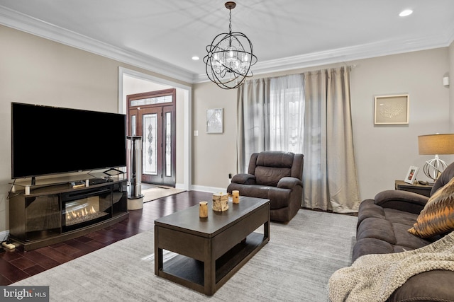 living room with a chandelier, crown molding, and dark hardwood / wood-style flooring