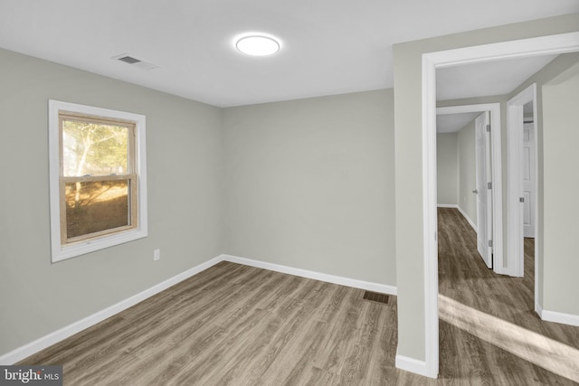 empty room with hardwood / wood-style flooring