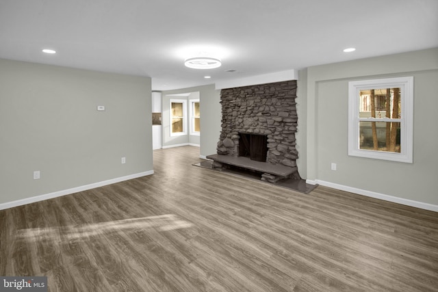 unfurnished living room featuring a fireplace and hardwood / wood-style flooring