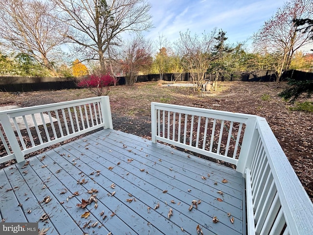 wooden deck featuring a trampoline