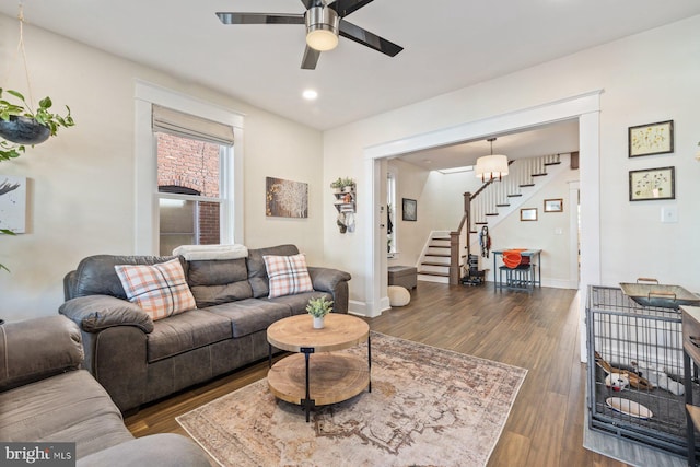 living room featuring ceiling fan and dark hardwood / wood-style flooring