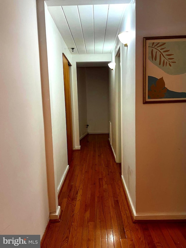 hall with hardwood / wood-style flooring