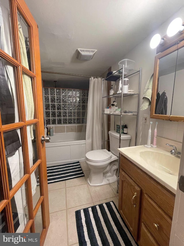 full bathroom featuring tasteful backsplash, shower / bath combo with shower curtain, vanity, tile patterned floors, and toilet