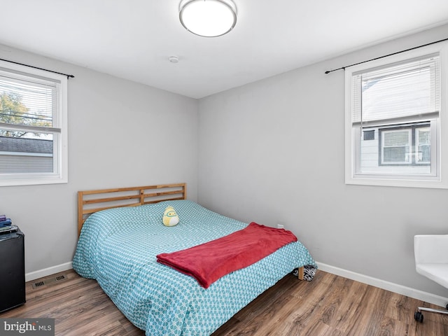 bedroom with hardwood / wood-style flooring