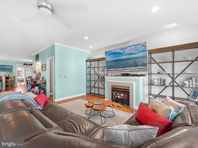 living room featuring hardwood / wood-style floors and crown molding