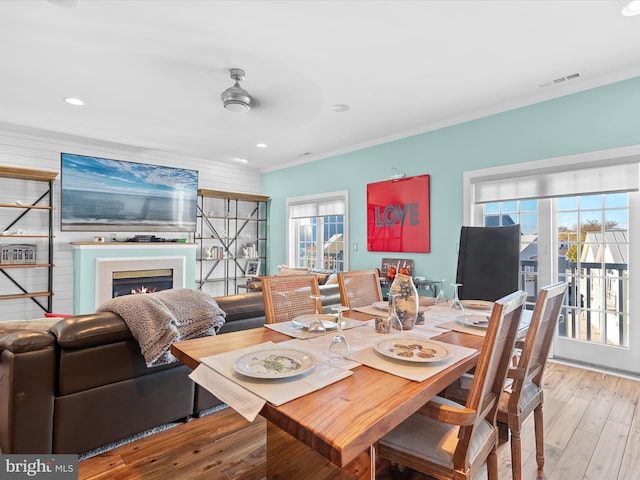 37601 Atlantic St Unit 8, Rehoboth Beach, DE 19971 - dining space with a lit fireplace, hardwood / wood-style floors, ornamental molding, and recessed lighting
