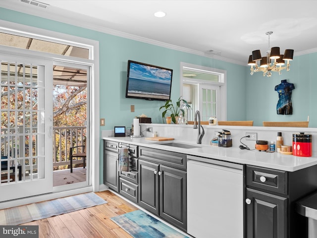 bar featuring light wood-type flooring, ornamental molding, white dishwasher, sink, and decorative light fixtures