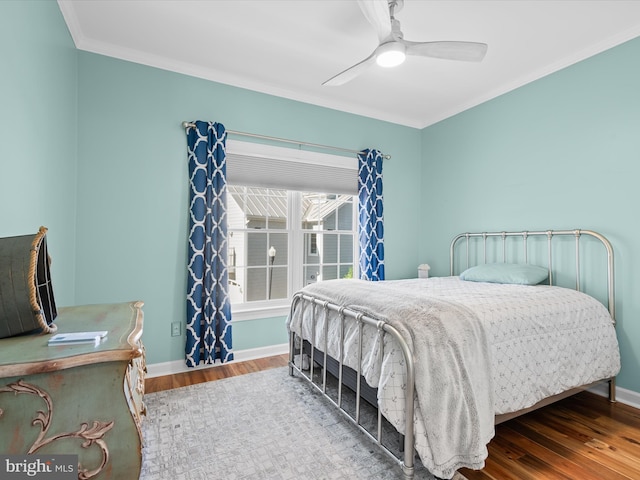 37601 Atlantic St Unit 8, Rehoboth Beach, DE 19971 - bedroom featuring wood finished floors, crown molding, baseboards, and a ceiling fan