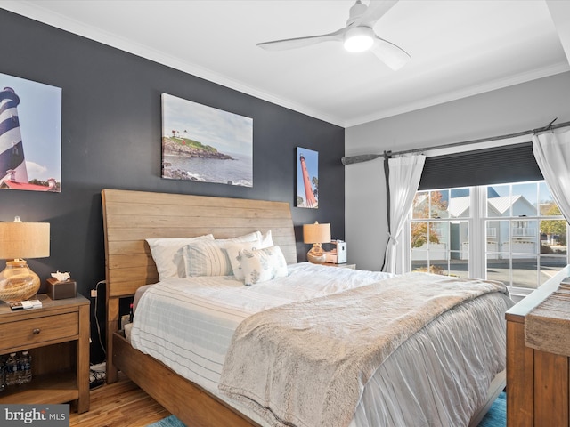 bedroom featuring hardwood / wood-style flooring, ceiling fan, and ornamental molding