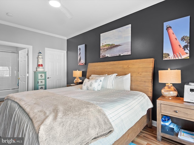 37601 Atlantic St Unit 8, Rehoboth Beach, DE 19971 - bedroom featuring crown molding, wood finished floors, ensuite bathroom, and a ceiling fan