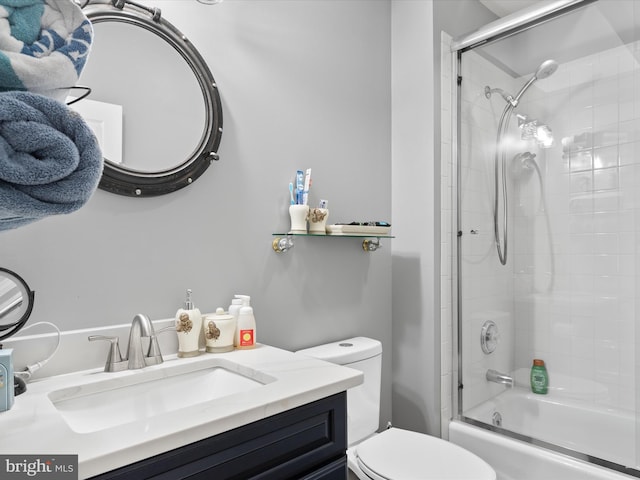 full bathroom featuring vanity, toilet, and bath / shower combo with glass door